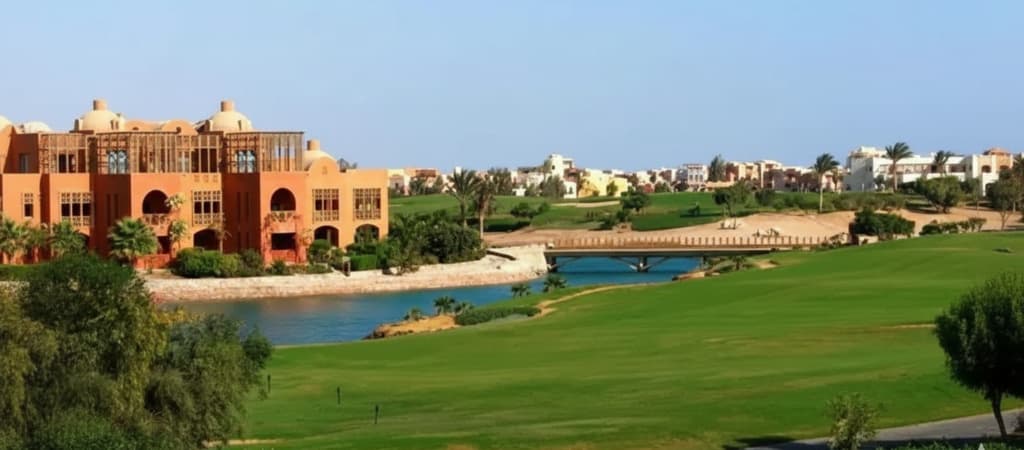 Orange buildings with canal and golf terrain in front